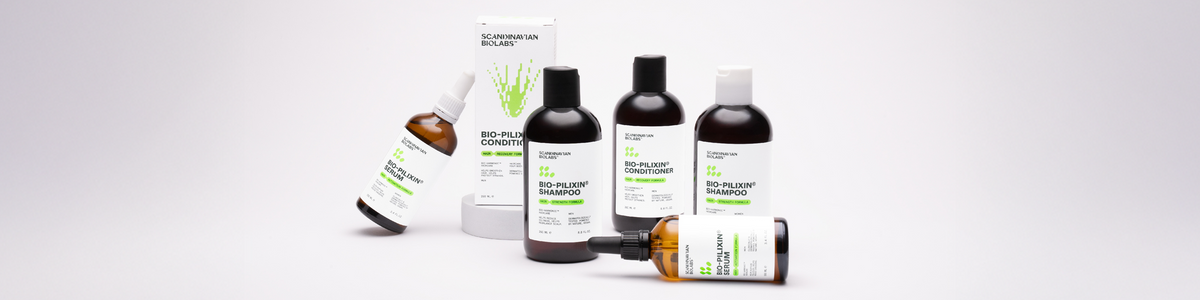 Fünf Haarpflegeprodukte von Scandinavian Biolabs, darunter Shampoo, Conditioner und Seren, auf weißem Hintergrund.