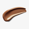 Ein glatter Fleck Skin Realist Tinted Balm in der Farbe 6 Dark auf weißem Hintergrund.