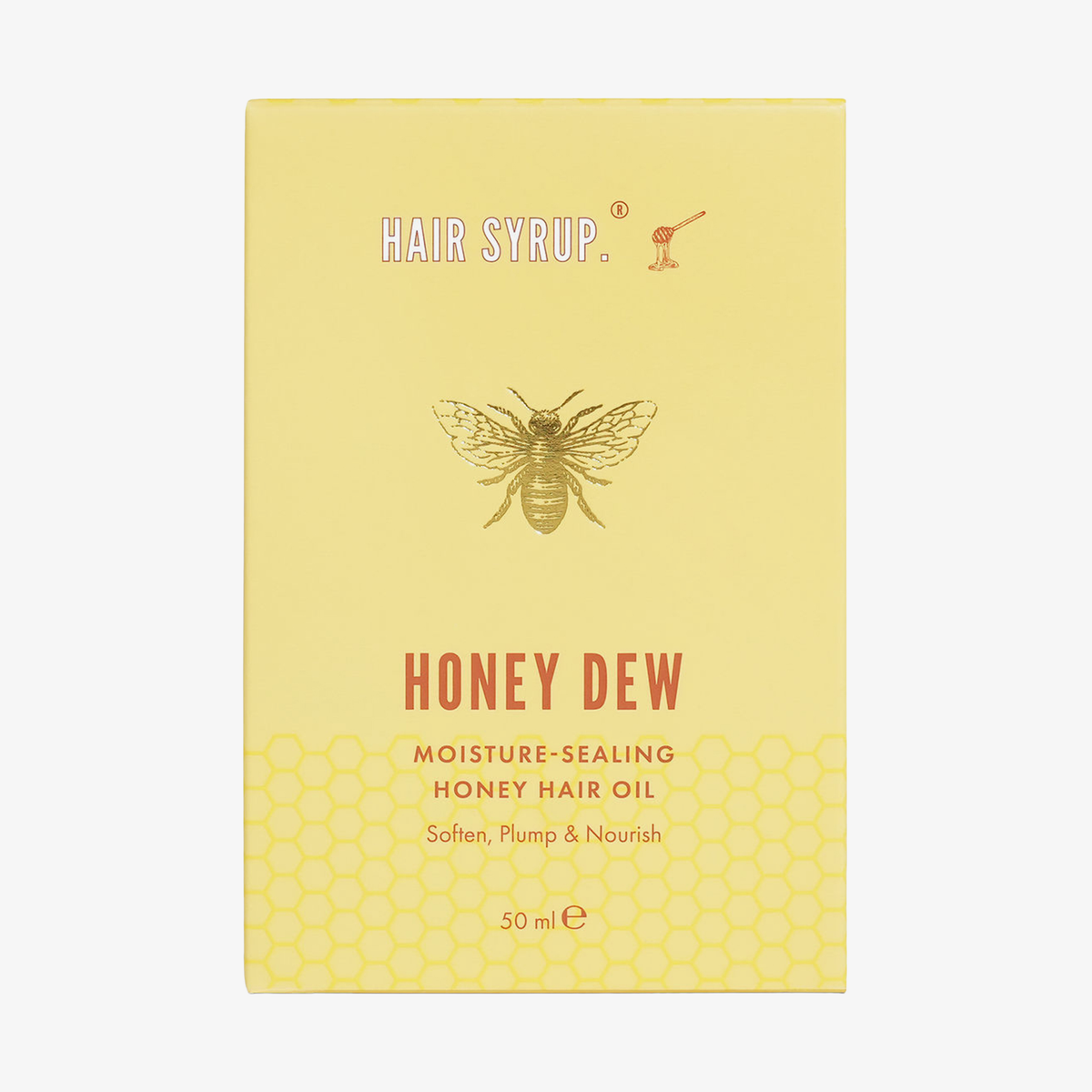 Gelbe Verpackung von Hair Syrup Honey Dew Haaröl mit Bienenmotiv und Wabenmuster; Produktname aufgedruckt.