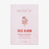 Hellrosa Verpackung des Rose Bloom Hair Oil von Hair Syrup mit Abbildung einer Rose und roter Schrift.