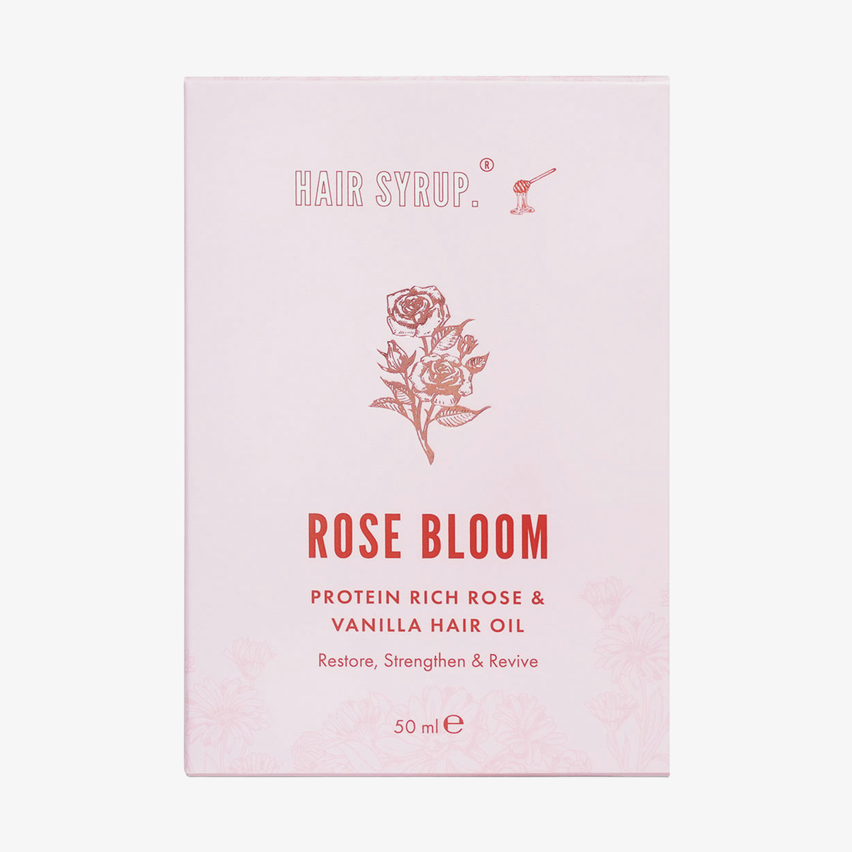 Hellrosa Verpackung des Rose Bloom Hair Oil von Hair Syrup mit Abbildung einer Rose und roter Schrift.