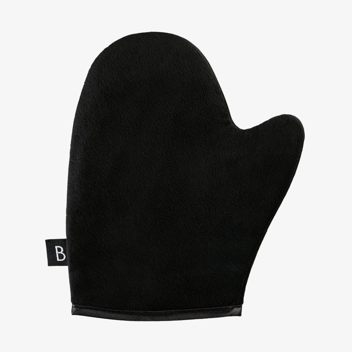 Der Luxe Tanning Mitt, ein schwarzer Fäustling mit kleinem Etikett an der Seite, vor weißem Hintergrund