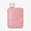 Eine rosane eckige Flasche Bali Body Tanning Oil SPF 6 Watermelon mit weißem Deckel vor weißem Hintergrund