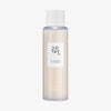 Mattierte transparente Flasche Glow Repleneshing Rice Milk von Beauty of Joseon mit weißem Deckel.