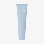 Hellblaue BLONDESISTER 2-IN-1 NATURAL BEAUTY getönte Creme LSF 15 in einer Tube vor einem schlichten weißen Hintergrund.