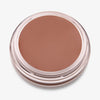 Ein runder offener Behälter mit Cronzer Cream Bronzer Sand mit braunem Inhalt auf weißem Hintergrund.