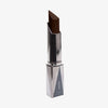 Shapestick Bronze & Define Cocoa in einem dunkelbraunem Ton in dreieckigem silbernem Drehgehäuse vor weißem Hintergrund.