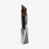 Shapestick Bronze & Define Espresso in einem dunklen neutralen Braun-Ton in dreieckigem silbernem Drehgehäuse vor weißem Hintergrund.