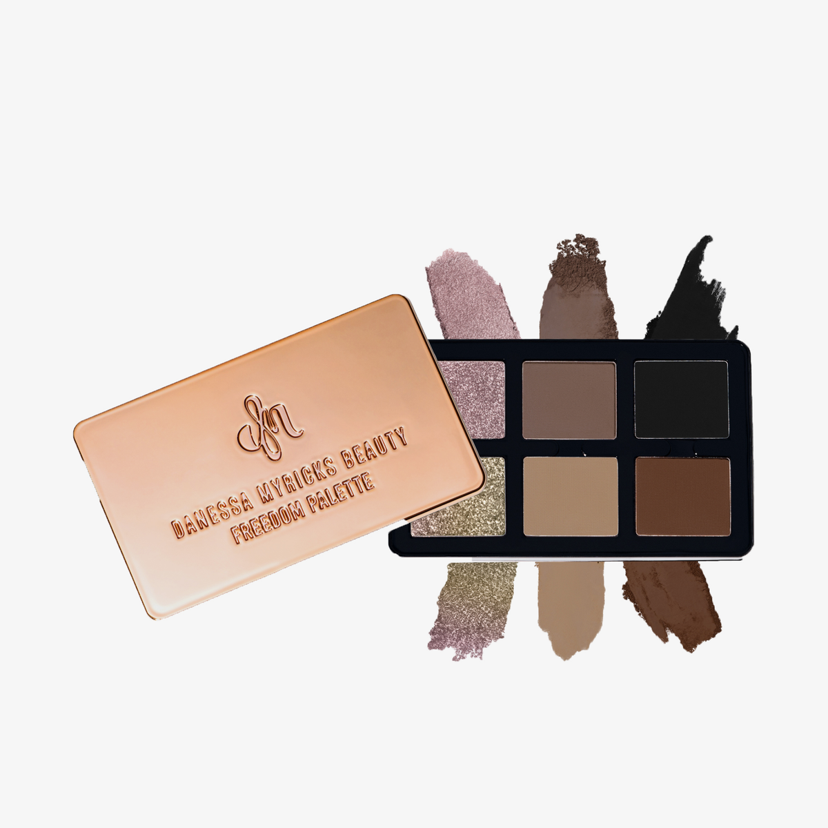 Geöffnete Danessa Myricks Beauty Freedom Palette mit sechs Lidschatten in Neutral- und Schimmertönen, daneben geschlossene roségoldene Palette.