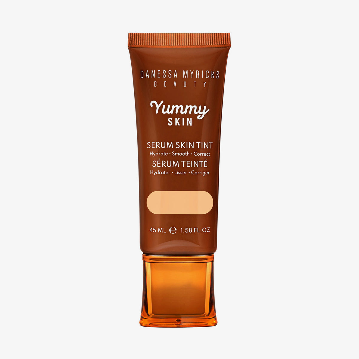 Bronzefarbene Tube der Yummy Skin Serum Tint 2 mit Sichtfenster zum beigen Produktinhalt.