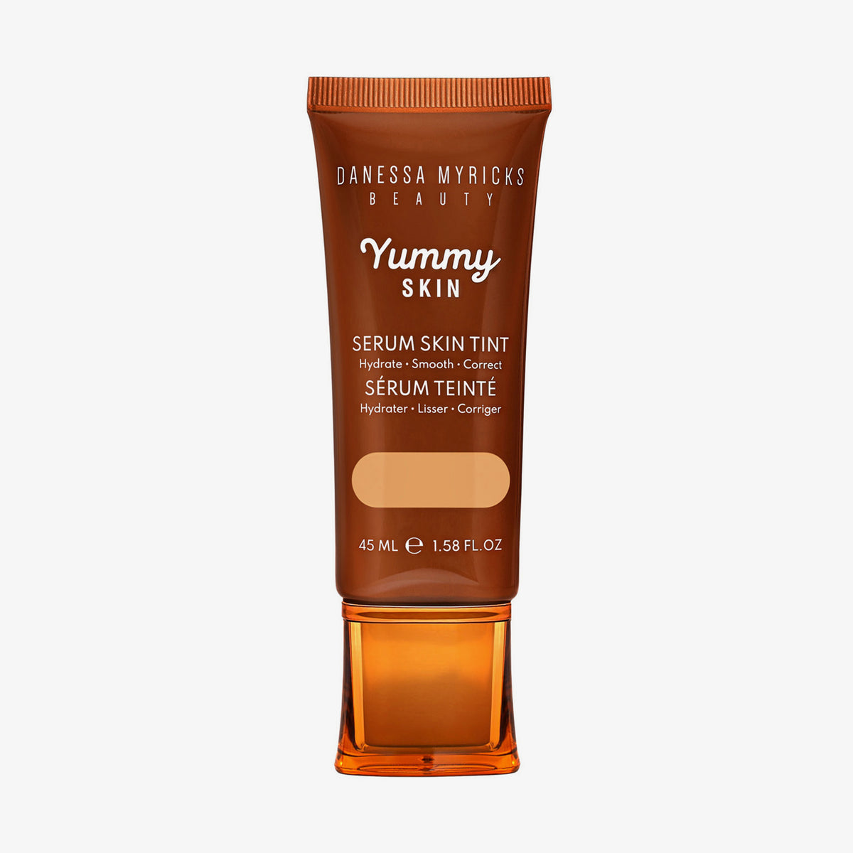 Bronzefarbene Tube der Yummy Skin Serum Tint 4 mit Sichtfenster zum mittelbeigem Produktinhalt.
