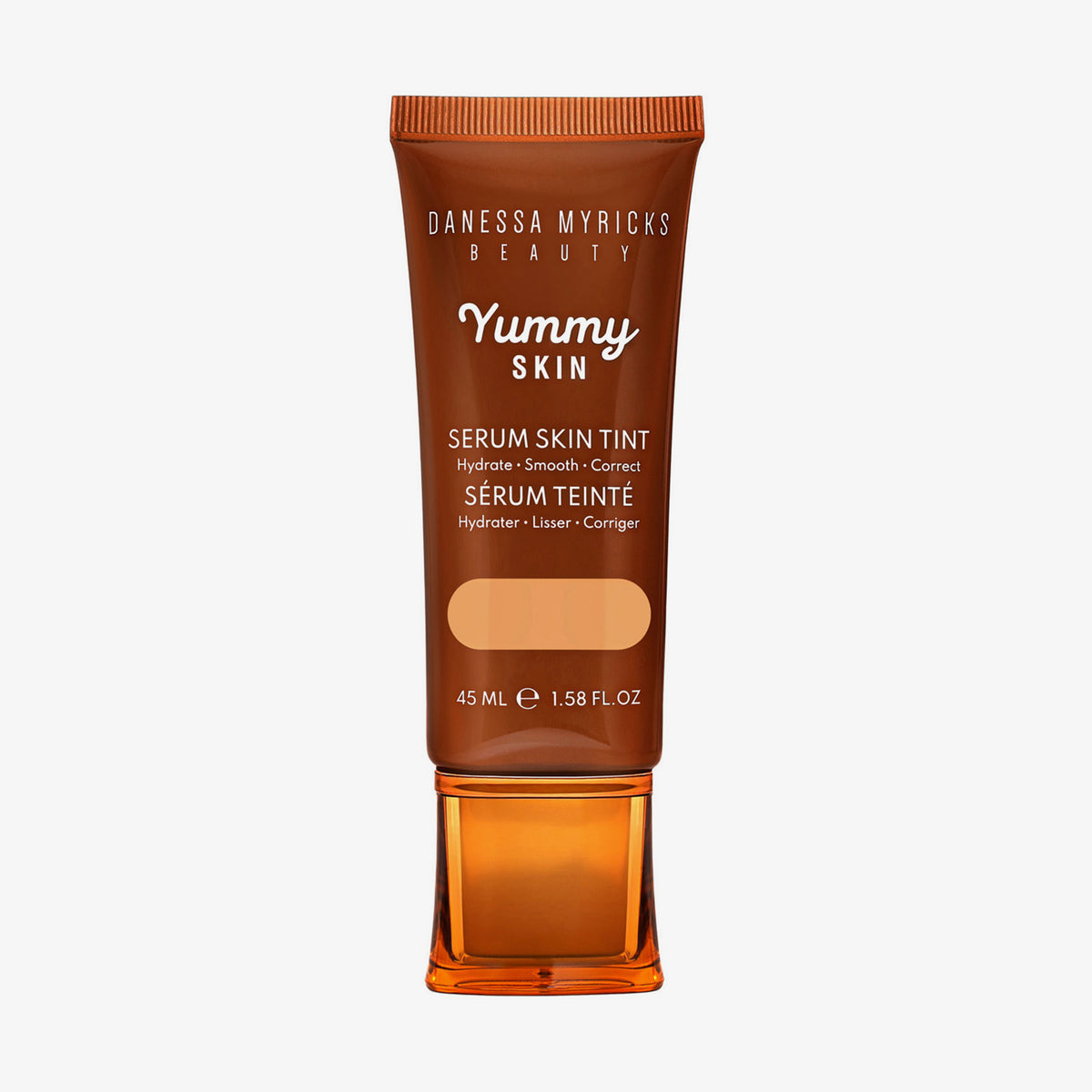 Bronzefarbene Tube der Yummy Skin Serum Tint 5 mit Sichtfenster zum warm-beigen Produktinhalt.