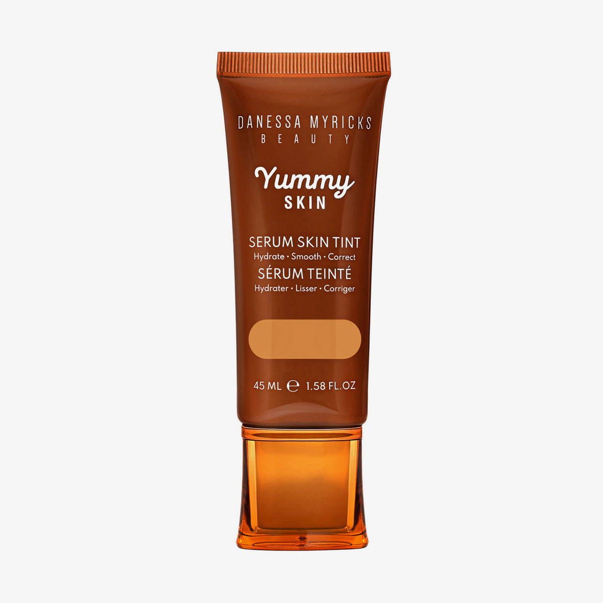 Bronzefarbene Tube der Yummy Skin Serum Tint 7 mit Sichtfenster zum warmem dunkelbeigem Produktinhalt.