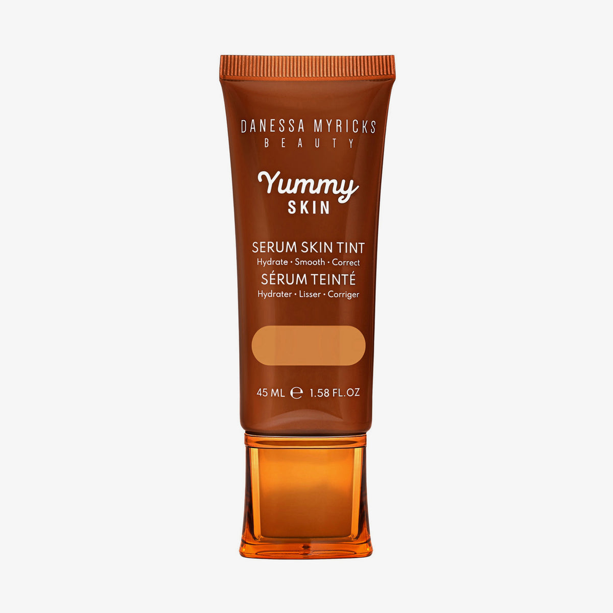 Bronzefarbene Tube der Yummy Skin Serum Tint 8 mit Sichtfenster zum warmem dunkelbeigem Produktinhalt.