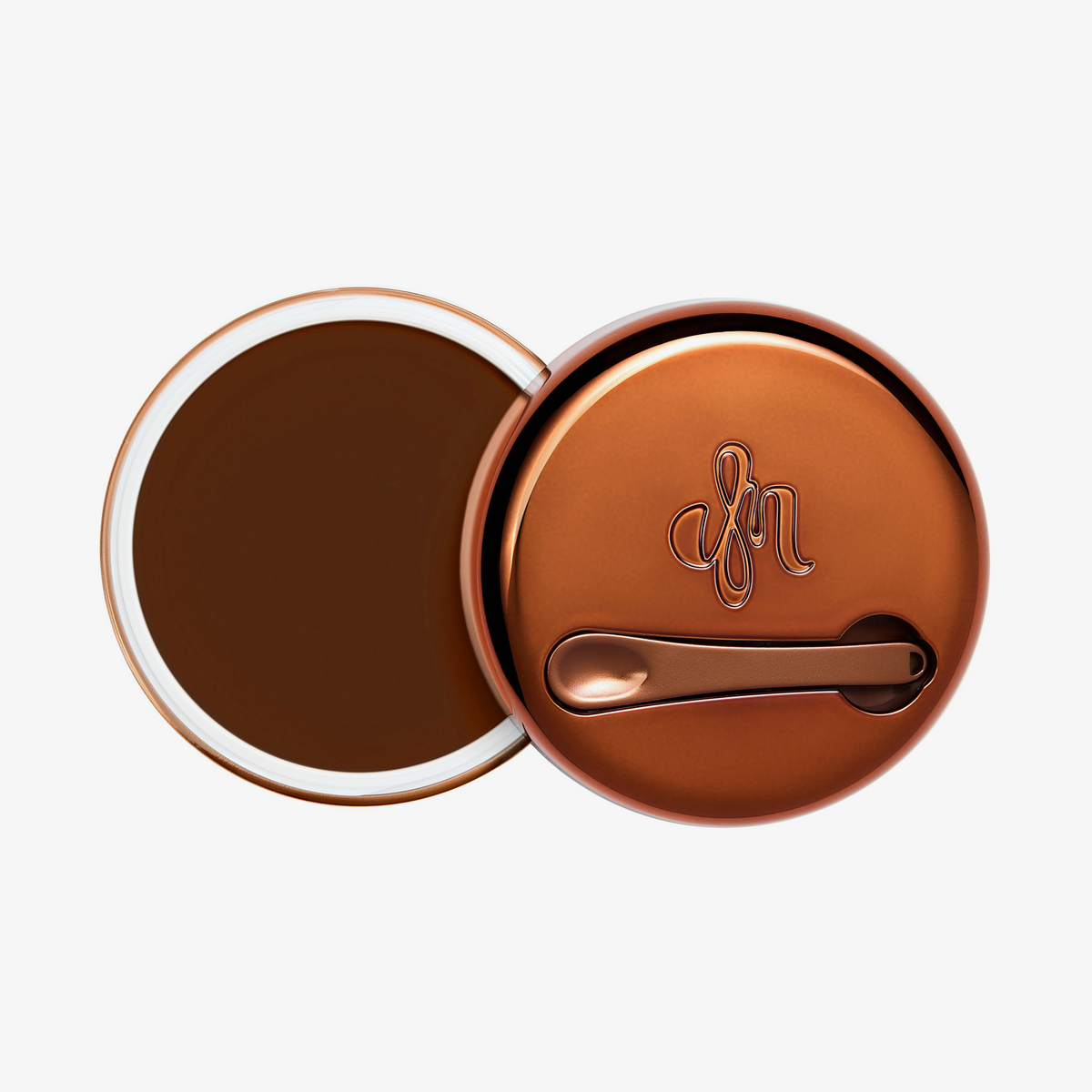 Runder geöffneter Behälter Yummy Skin Blurring Balm Shade 10 mit bronzefarbenem Deckel und kleinem Applikator.