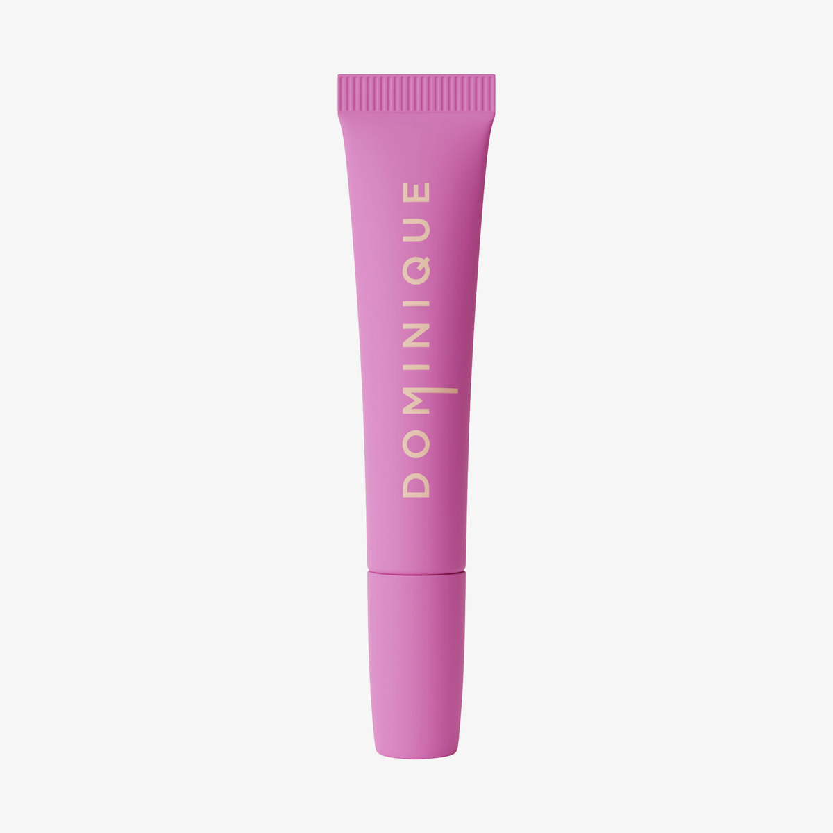 Eine rosafarbene Tube Dominique Cosmetics Juicy Lip Balm steht aufrecht auf einem weißen Hintergrund, das goldene Etikett "DOMINIQUE" ist sichtbar.