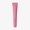 Eine rosafarbene Tube von Dominique Cosmetics Juicy Lip Balm steht aufrecht vor einem weißen Hintergrund.