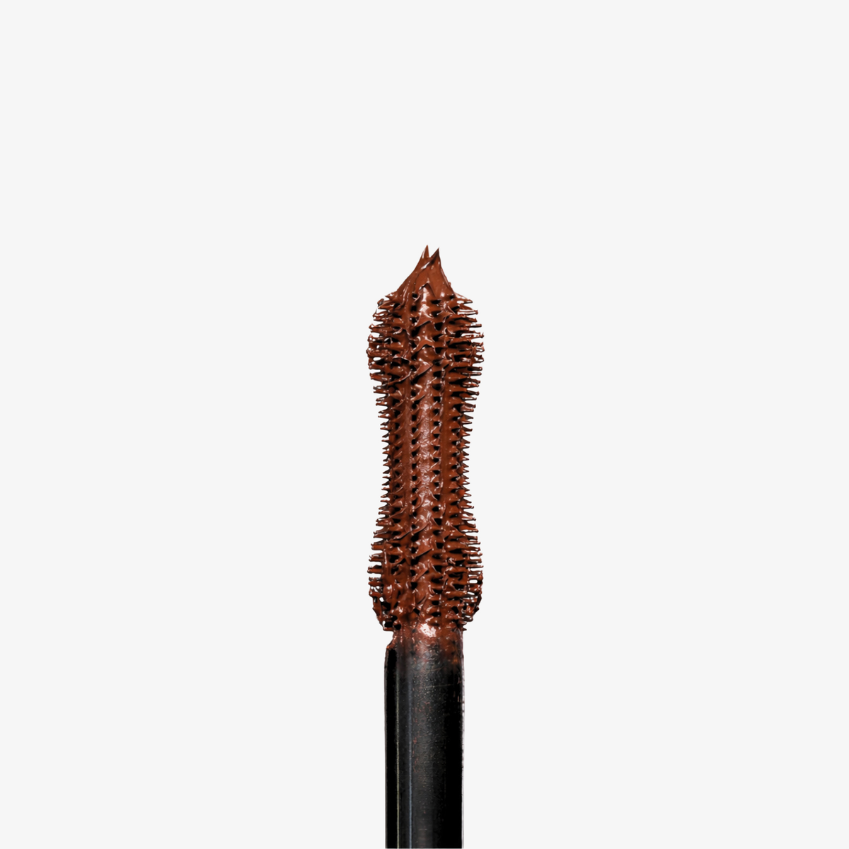 Nahaufnahme des Dominique Cosmetics Lash Lift Tubing Mascara-Stabs mit brauner Wimperntusche vor einem schlichten weißen Hintergrund.