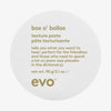 Ein weißer runder Tiegel Box O Bollox Texture Paste mit humorvoller Produktbeschreibung auf dem Deckel.