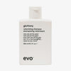Weiße Flasche Gluttony Volume Shampoo mit humorvollem Produkttext vor weißem Hintergrund.