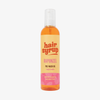 Eine Flasche Hair Syrup Rapunzel Pre-Wash Oil, 300ml, mit einem rosa-orangefarbenen Etikett ist auf weißem Hintergrund abgebildet.