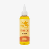 Eine Flasche Hair Syrup Vitamin C Me, 100ml, Haaröl mit Orangen-, Papaya- und Macadamia-Öl vor hellem Hintergrund.