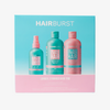 Blaue-rosane Box des Volume & Growth Elixir Bundle; darauf sind drei rosa und blaugrüne Haarpflegeflaschen zu sehen.