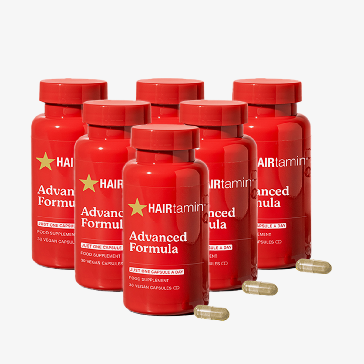 Sechs Flaschen „HAIRtamin Advanced Formula“ im 6-Monats-Paket mit drei Kapseln im Vordergrund vor einem weißen Hintergrund.