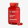 Eine rote HAIRtamin Gummy Stars™-Flasche für einen Monat mit roten, sternförmigen Gummibärchen daneben auf weißem Hintergrund.