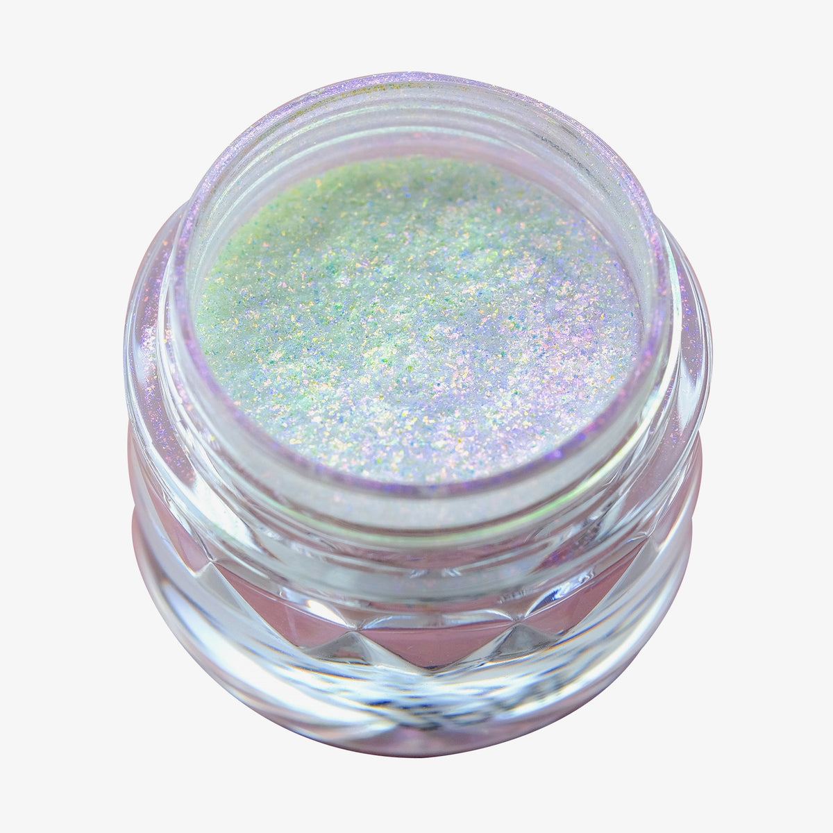 Offener transparenter Tiegel des Opal Multichrome Loose Eyeshadow Night Kiss mit lila-grün und weiß schimmerndem Glitzer auf weißem Hintergrund.