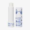Weißer Drehstift des KORRES Lip Balm mit blauem Vogelmotiv, Yoghurt-Geschmack und LSF 20 ist aufrecht und ohne Deckel abgebildet.