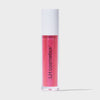Eine transparente Tube Glazed Sugar von LH Cosmetics mit weißem Deckel und pink glitzerndem Inhalt vor weißem Hintergrund.
