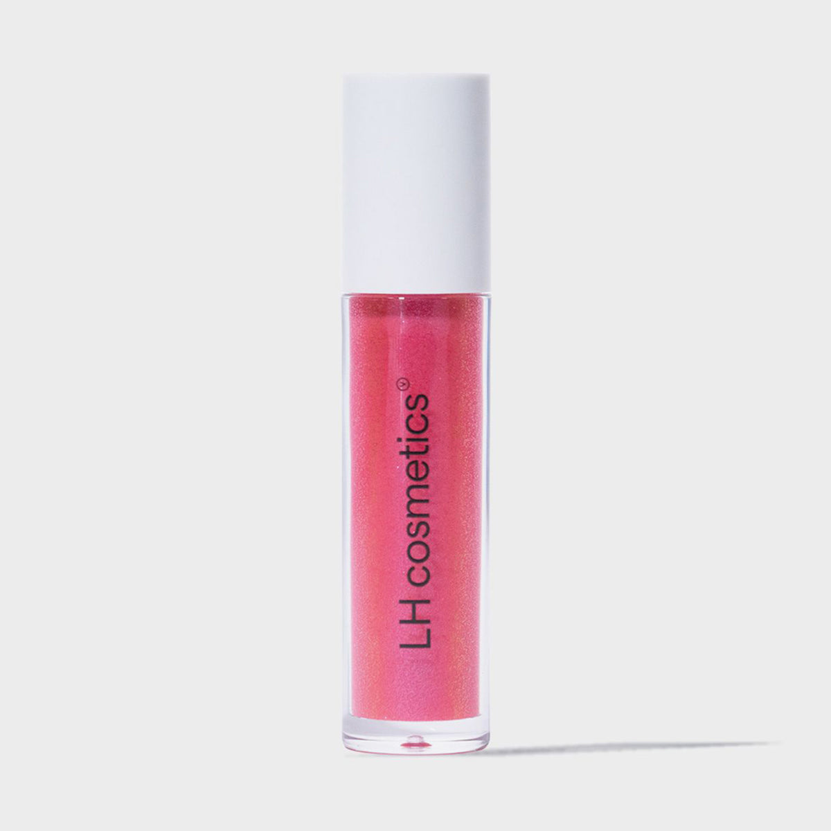 Eine transparente Tube Glazed Sugar von LH Cosmetics mit weißem Deckel und pink glitzerndem Inhalt vor weißem Hintergrund.