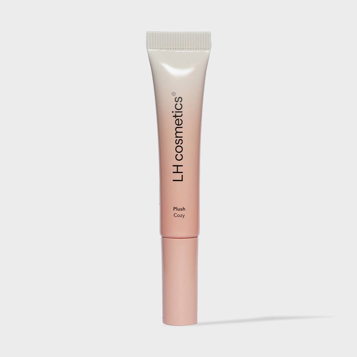 Eine Tube Plush Cozy von LH Cosmetics mit weiß-rosa Farbverlauf auf weißem Hintergrund.