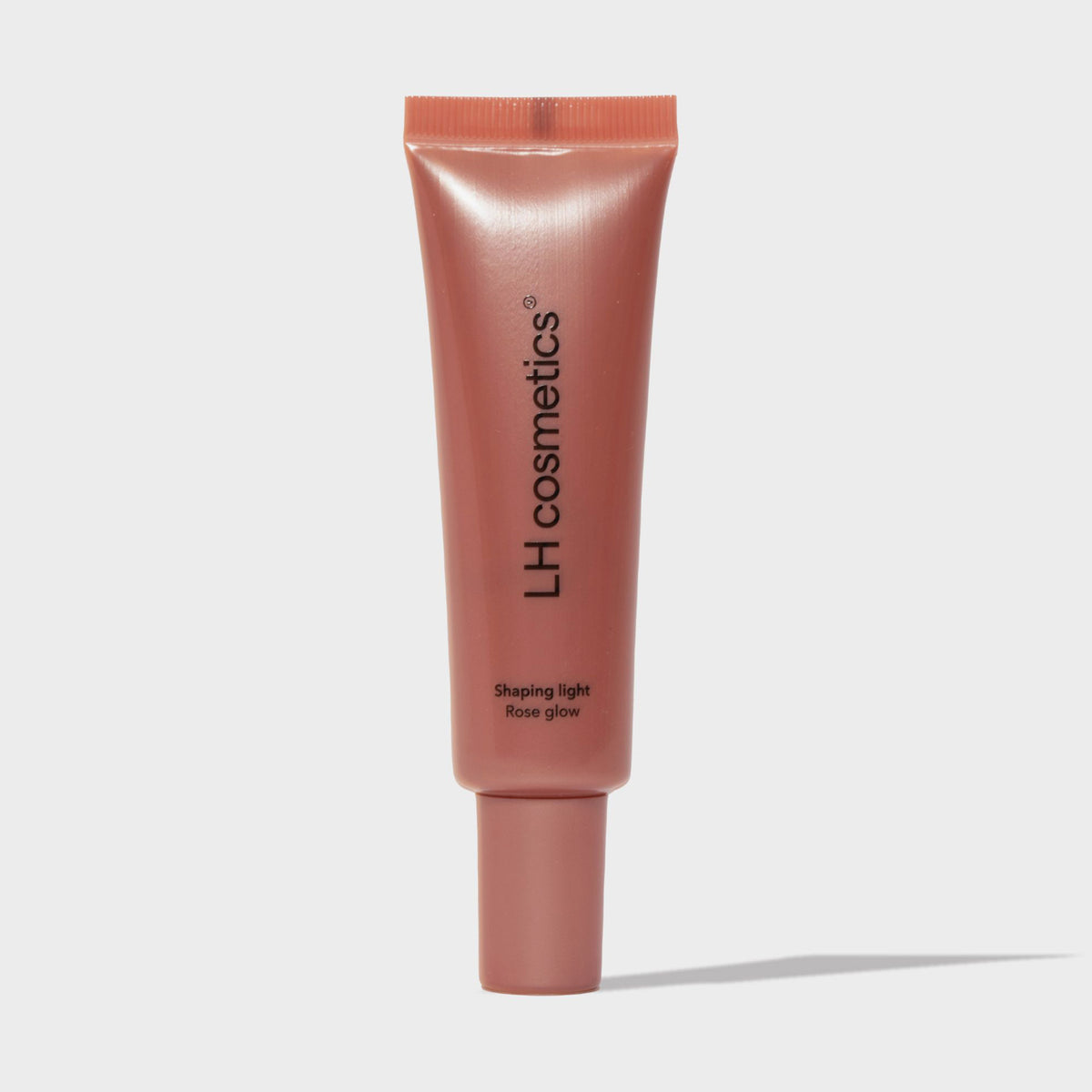 Eine roséfarbene Tube LH Cosmetics Shaping Light Rose Glow steht vor einem weißen Hintergrund.