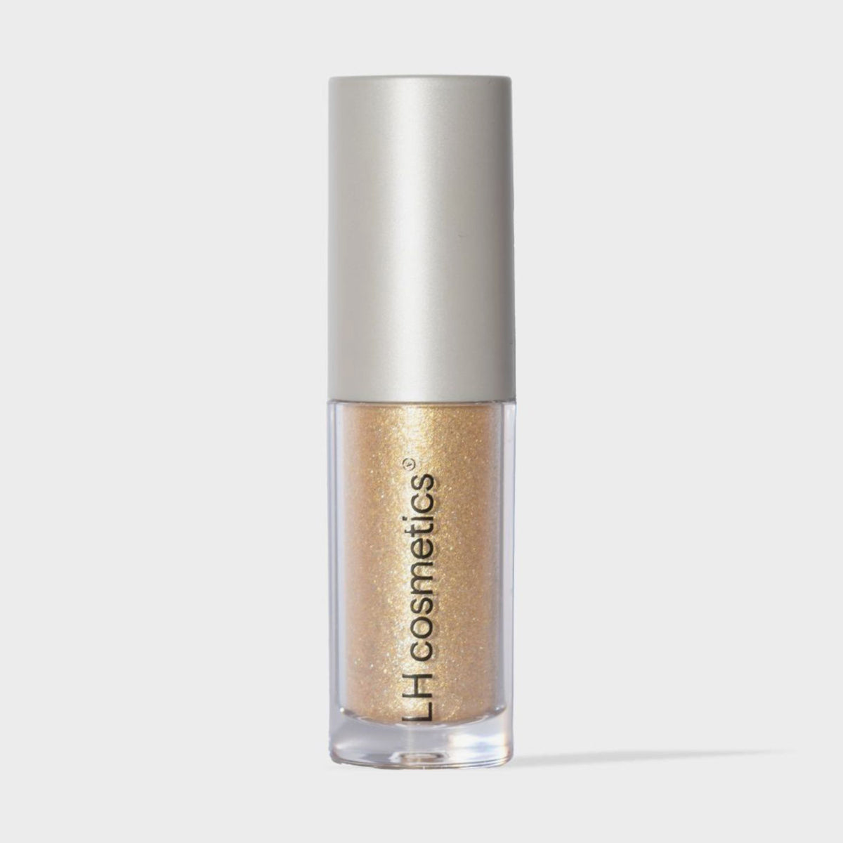 Transparente Tube Sparkl von LH Cosmetics mit weißer Kappe und gelb-gold schimmerndem Farbton namens Charm.