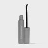 Eine graue Tube LH Cosmetics The Brow Wax mit sichtbarem schwarzen Stab und gebogener Bürste.