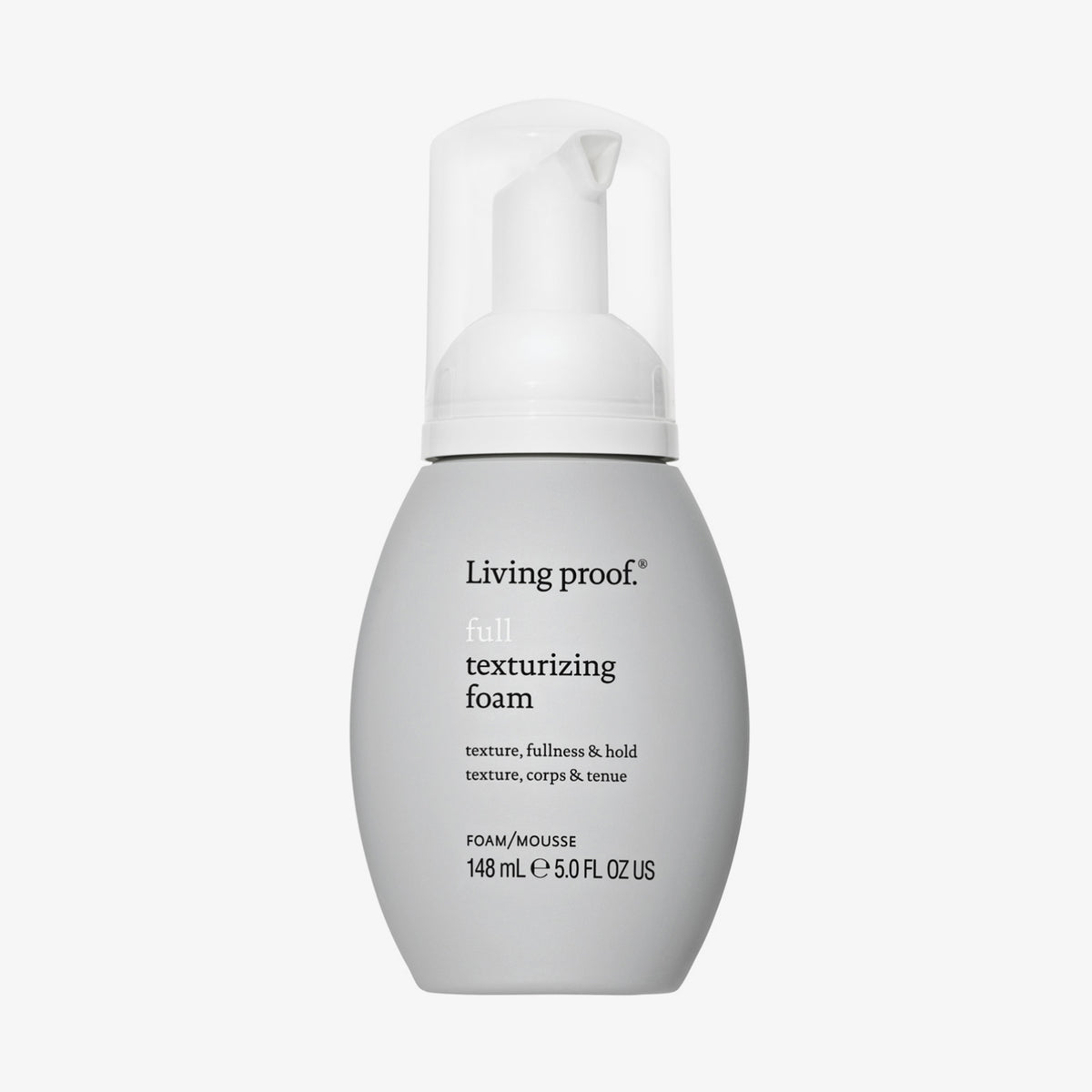 Bauchige graue Flasche Living Proof Full Texturizing Foam mit weißem Pumpspender vor weißem Hintergrund.