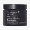 Schwarzer Tiegel Style Lab Amp Texture Volumizer von Living Proof vor weißem Hintergrund.