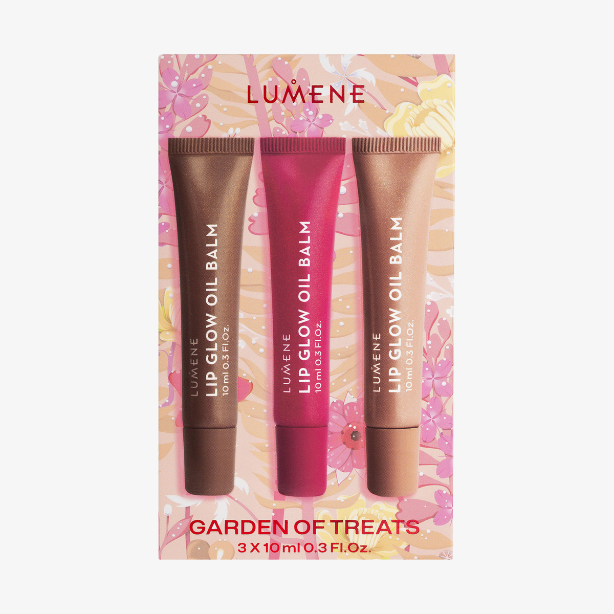 Drei Lumene GARDEN OF TREATS SET 2026 Lip Glow Oil Balms in den Farben Rosa, Rot und Bronze vor einem floralen Hintergrund.