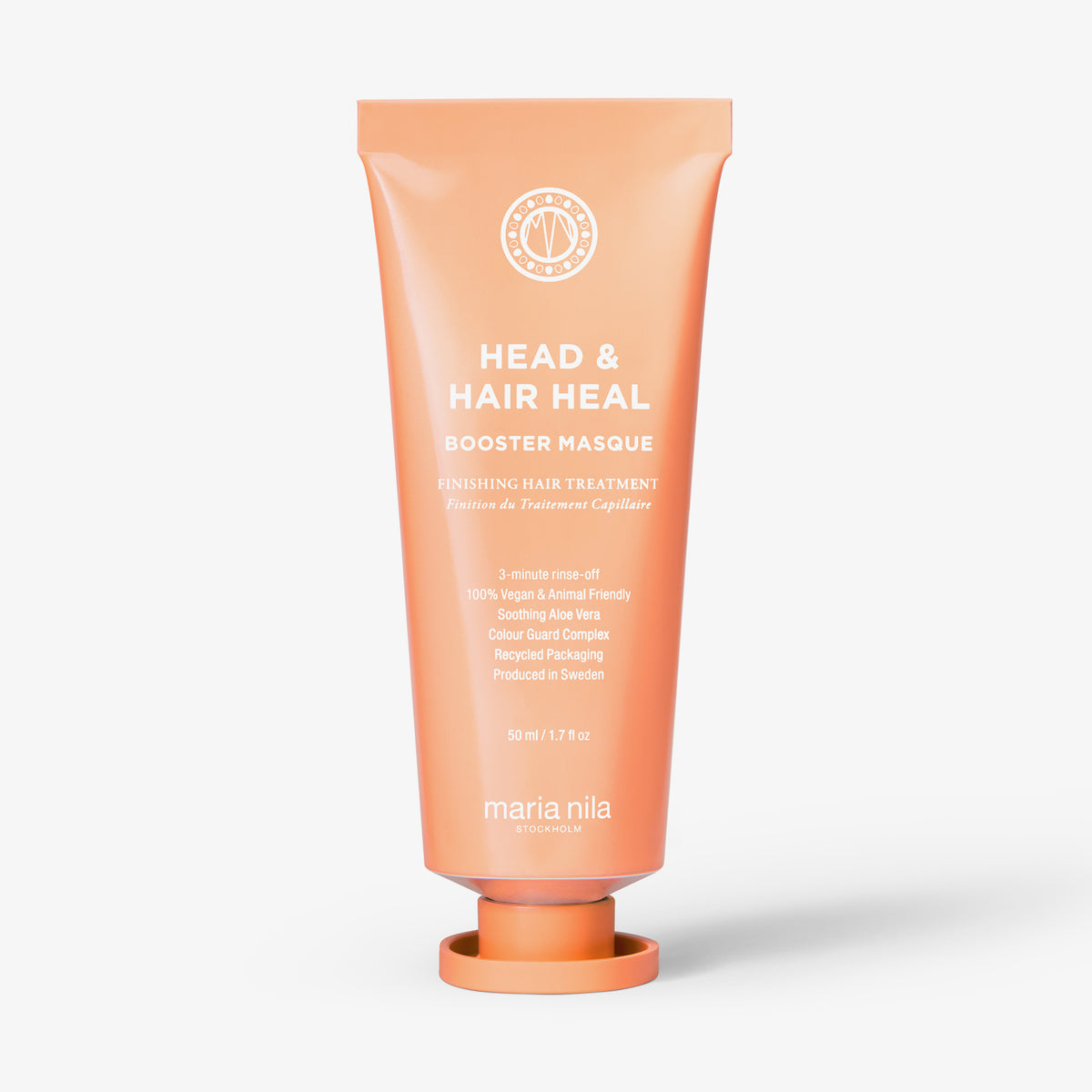 Pfirsichfarbene Tube der maria nila Booster Masque Head & Heal aufrecht vor weißem Hintergrund.