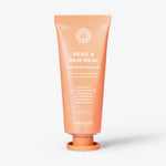 Pfirsichfarbene Tube der maria nila Booster Masque Head & Heal aufrecht vor weißem Hintergrund.