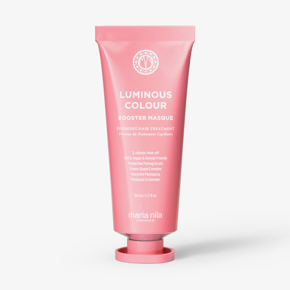Eine rosafarbene Tube der maria nila Booster Masque Luminous Colour steht aufrecht vor einem weißen Hintergrund.
