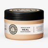 Ein pfirsichfarbener Tiegel der maria nila Head & Hair Heal Masque mit schwarzem Deckel auf weißem Hintergrund.