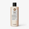 Pfirsichfarbene Flasche Head & Hair Heal Shampoo von maria nila mit schwarzem Deckel auf weißem Hintergrund.