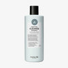 Hellblaue Flasche maria nila Purifying Cleanse Shampoo mit einer schwarzen Kappe, dargestellt vor einem weißen Hintergrund.