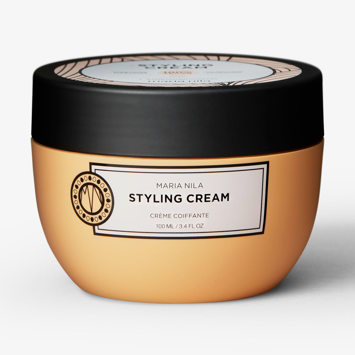 Oranger runder Tiegel der maria nila Styling Cream mit schwarzem Deckel und weißem Etikett.