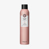 Rosafarbene Sprühflasche Maria Nila Volumen Spray mit schwarzer Kappe und weißem Etikett.