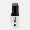 Ein silber-schwarzer Make-up-Stick mit dem leicht herausgedrehten The Mood Contrast 102 Medium von Mesauda vor weißem Hintergrund.