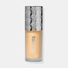 Die Flasche Flush of Light Blossom Shine von Mesauda mit silbergemustertem Deckel und gold-gelbem Inhalt.